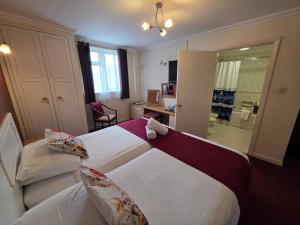 a hotel room with a large bed and a desk at Marina Metro Hotel in Saint Helier Jersey