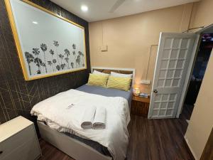 a small bedroom with a bed with towels on it at 1BHK CASA BELLA Off Linking rd Ground floor in Mumbai