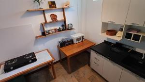 a small kitchen with a table and a microwave at Tropical Sea Front House in Ko Po