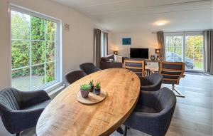 a living room with a wooden table and chairs at Awesome Stacaravan In Goedereede With Wifi in Goedereede