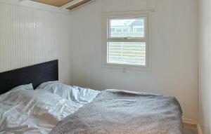 a bed in a white room with a window at 3 Bedroom Cozy Home In Korsør in Tjæreby
