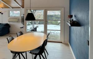 a dining room with a wooden table and chairs at 3 Bedroom Cozy Home In Korsør in Tjæreby