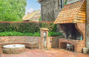 a brick fireplace in front of a house at 3 Bedroom Beautiful Home In Renty in Renty +26 photos