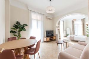 a living room with a table and a couch at MainAvenue White Tower in Thessaloniki