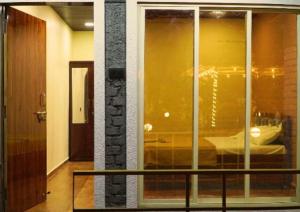 a room with a window with a view of a bed at Evergreen bliss farm in Karjat