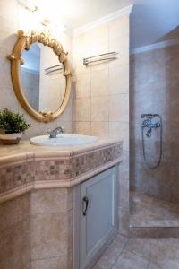 a bathroom with a sink and a shower with a mirror at MainAvenue White Tower in Thessaloniki +35 photos