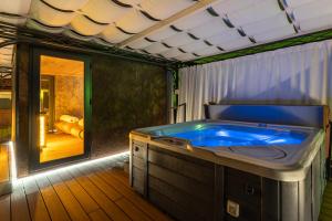 a jacuzzi tub in the middle of a room at Hotel Opinione Dimora Storica & Private Spa in San Lorenzo in Banale +90 photos