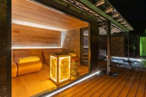 a sauna with a bench and a table in a room at Hotel Opinione Dimora Storica & Private Spa in San Lorenzo in Banale