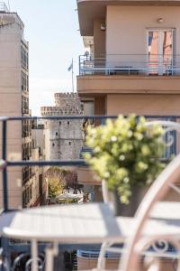 a balcony with a potted plant on a building at MainAvenue White Tower in Thessaloniki
