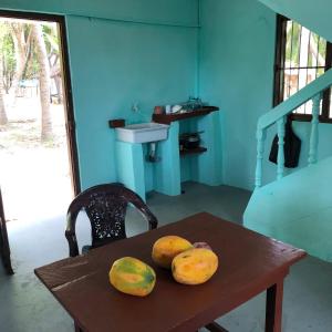 a wooden table with fruit on it with a sink at Thapovanam Veedu in Allaippiddi