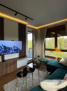 a living room with a couch and a flat screen tv at Apartman A&N Zlatibor in Zlatibor