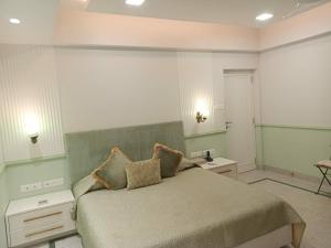 a bedroom with a bed with two night stands and two tables at Beach villa South Goa in Arossim-Cansaulim +2 photos