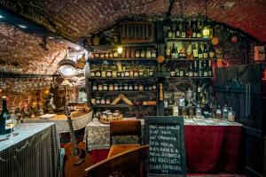 a room with a bar with a table with a guitar at Varsádi Birtok Piano in Somlóvásárhely +9 photos
