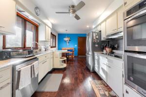a kitchen with white cabinets and a blue wall at Spacious 4BR Home with BBQ Yard Near Golf Course in Rockford