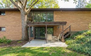 a patio with a table and chairs in front of a building at Spacious 4BR Home with BBQ Yard Near Golf Course in Rockford +22 photos