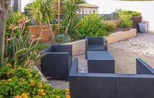 two blue benches in a garden with plants at Villa La Playa in Saint-Raphaël +12 photos