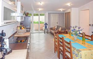 a kitchen and living room with a table and a couch at Villa La Playa in Saint-Raphaël