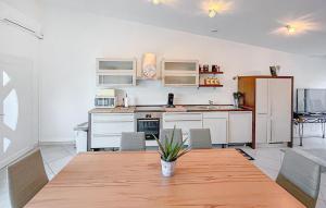 a kitchen with a wooden table and a dining room at Villa La Playa in Saint-Raphaël
