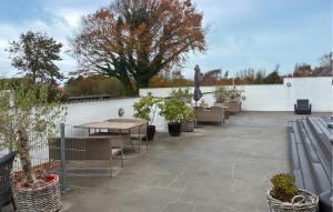 a patio with tables and chairs and potted plants at 7 Bedroom Stunning Home In Samsø in Kolby Kås +11 photos
