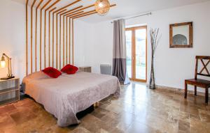 Un dormitorio con una cama con almohadas rojas. en Nice Home In St Cirgues De Prades With Private Swimming Pool, Can Be Inside Or Outside, en Jaujac 17 fotos más