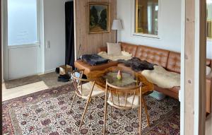 a living room with a couch and a table at 1 Bedroom Beautiful Home In Samsø in Kolby Kås