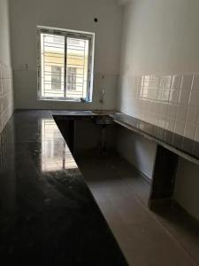 an empty bathroom with a sink and a window at Stay Place in kolkata