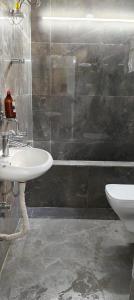 a bathroom with a sink and a toilet and a tub at Stay Place in kolkata +7 photos