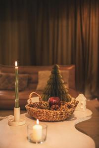 a table with a basket of fruit and a candle at Rycerki Dom na Szlaku in Rajcza