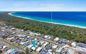 an aerial view of a beach with houses and the ocean at Coastal Nest - Walk to Windang Beach in Windang