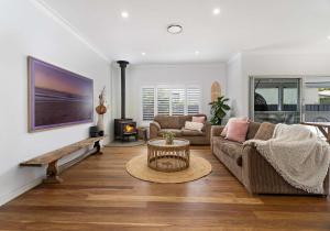 a living room with a couch and a table at Coastal Nest - Walk to Windang Beach in Windang