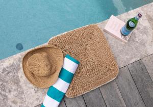 a straw hat and a bottle of water and a drink at Coastal Nest - Walk to Windang Beach in Windang