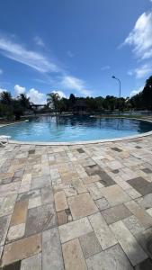 a swimming pool with blue water in a park at Flat Resort ILOA in Barra de São Miguel +8 photos