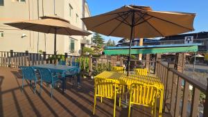 a table and chairs with umbrellas on a deck at 여주여행자센터 호스텔 in Yeoju