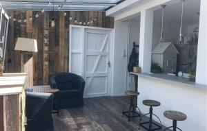 a living room with a blue chair and a door at Cozy Home In Scharendijke With Private Swimming Pool, Can Be Inside Or Outside in Scharendijke