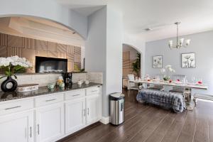 a kitchen with white cabinets and a dining table at Welcome to enjoy your home in Dallas