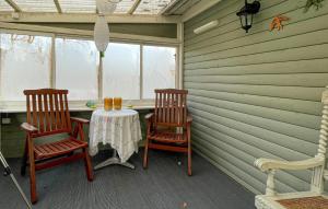 two chairs and a table in a room with a window at Stunning Home In Mårdaklev With Wifi in Boda +19 photos