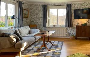 a living room with a couch and a table at Stunning Home In Mårdaklev With Wifi in Boda