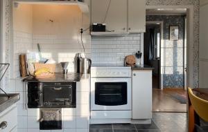 a kitchen with a stove and a white oven at Stunning Home In Mårdaklev With Wifi in Boda