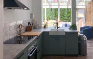 a kitchen with a sink and a large window at Cozy Home In Scharendijke With Private Swimming Pool, Can Be Inside Or Outside in Scharendijke