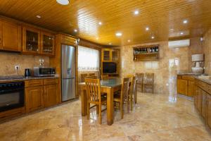 a large kitchen with a table and chairs in it at A Casa dos Amigos - Termas São Vicente in Penafiel