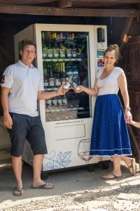 Ein Mann und eine Frau stehen vor einem Kühlraum in der Unterkunft Mein Wein Appartment in Krems an der Donau