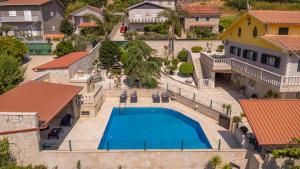 an aerial view of a house with a swimming pool at A Casa dos Amigos - Termas São Vicente in Penafiel