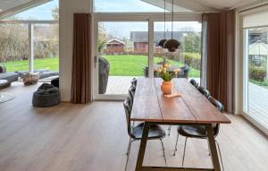 a dining room with a wooden table and chairs at 3 Bedroom Awesome Home In Haderslev in Kelstrup Strand