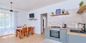 a kitchen with a sink and a table with chairs at Pino 1 in Veli Lošinj +13 photos