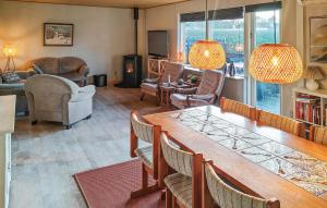 a living room with a large wooden table and chairs at 3 Bedroom Beautiful Home In Hjørring in Mejeriby