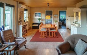 a living room with a table and a kitchen at 3 Bedroom Beautiful Home In Hjørring in Mejeriby