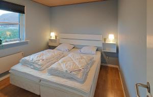 a bed in a bedroom with two pillows at 3 Bedroom Beautiful Home In Hjørring in Mejeriby
