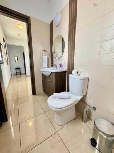 a bathroom with a toilet and a sink at Aurora Gardens Villa Spacious 3 Bedroom in Protaras in Paralimni +28 photos