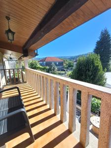 a porch with a wooden deck with a bench at alma de quireza in Santo Tomé