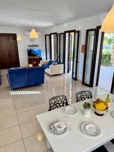 a living room with a white table and chairs at Aurora Gardens Villa Spacious 3 Bedroom in Protaras in Paralimni